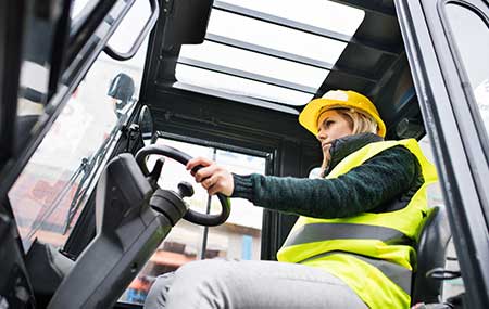 a worker holding steering of forklift